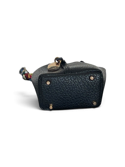Bagsational black pebbled leather mini bucket bag charm with gold hardware and protective feet, bottom view.